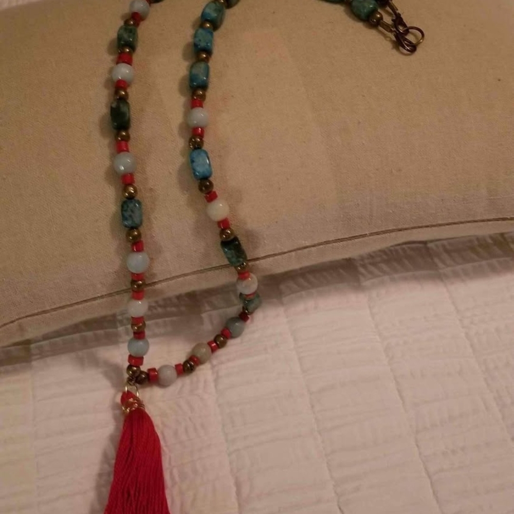Elegant Beaded Necklace with Red Tassel